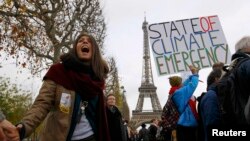Активисты-экологи проводят акцию в день окончания конференции ООН по климату. Париж, 12 декабря 2015 года.