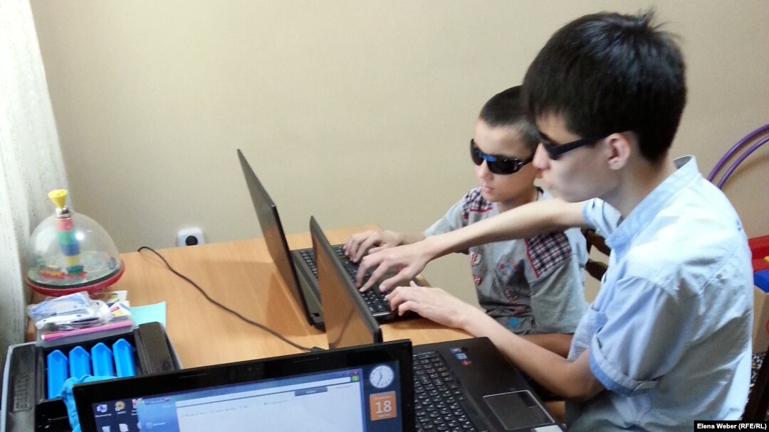 Adil Uralbaev (right), who was born without sight, says the Internet changed everything for him.