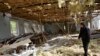 Nagorno-Karabakh -- A man walks inside a destroyed building in the village of Talish, some 80km north of Karabakh's capital Stepanakert, April 6, 2016