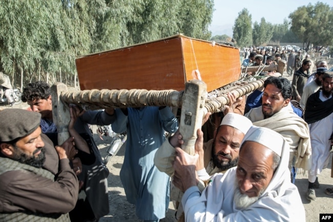 Afghan relatives and mourners carry the coffin of a victim killed in an overnight Pakistani air strike during a mass burial ceremony at the Girdi Kas village in Bihsud district, Nangarhar Province on February 22.
