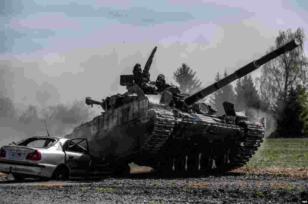 A Ukrainian T-64BM tank goes over a car during the Strong Europe Tank Challenge 2017 at a training ground near Eschenbach in Germany on May 11. (epa/Christian Bruna)