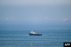 Cargo ships are pictured off the coast of the Khor Fakkan Container Terminal, along the Gulf of Oman on June 19.