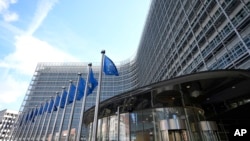 Belgium - European Union flags flap in the wind outside EU headquarters in Brussels, March 25, 2024.