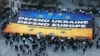 Activists unfurl a large banner in support of Ukraine outside the European Council building ahead of an EU summit in Brussels on March 5. 