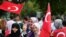 People holding Turkish flags rally on the first anniversary of the failed coup attempt in Istanbul.