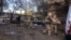 Rescue workers carry the bodies of victims from the scene of a Russian air strike in Kyiv on September 8.