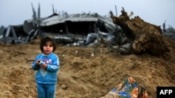 A Palestinian girl stands amid the ruins of destroyed houses on the outskirts of Jabalia refugee camp in the northern Gaza Strip on January 19.