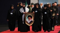 Women react as they walk to pay their respects near the coffins of Iran's late Supreme Leader Ayatollah Ali Khamenei and his family members, at the Imam Khomeini Grand Mosalla in Tehran on July 3. 