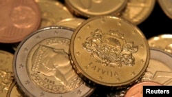 The euro will replace the country's current currency, the lat, though both currencies will be legal tender for the first 14 days of the new year before the lat is dropped.