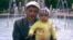 A file photo of Reshat Ametov with one of his children. The Crimean Tatar activist's killing in 2014 is still unsolved. 