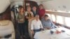 Former Kyrgyz President Almazbek Atambaev (seated left) and his associates head to Moscow aboard a private jet on July 24.