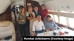 Former Kyrgyz President Almazbek Atambaev (seated left) and his associates head to Moscow aboard a private jet on July 24.