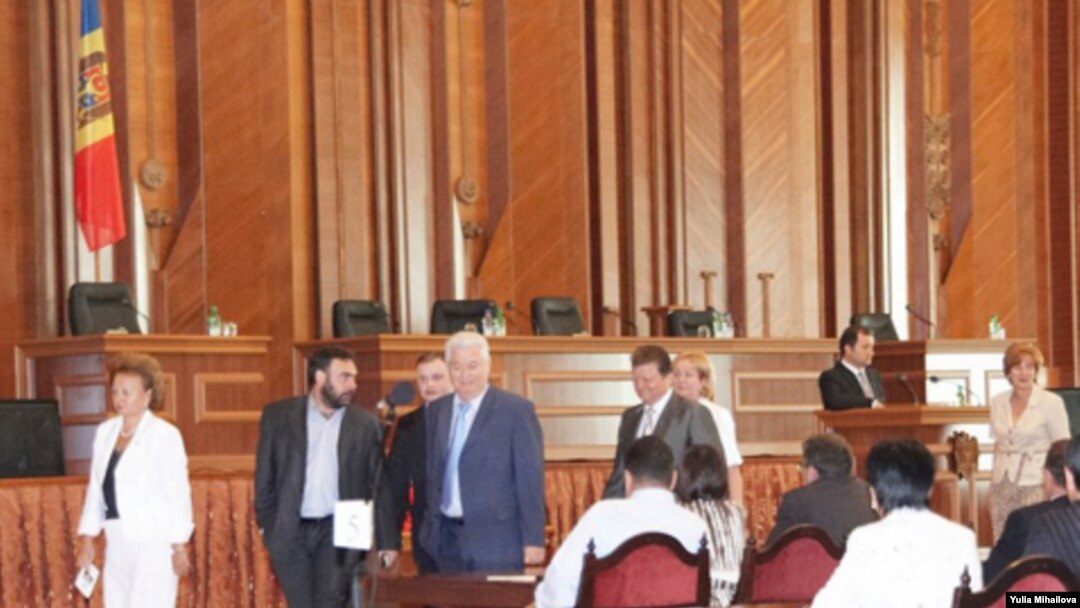 Moldovan President Vladimir Voronin (center) and fellow Communists walk out of a session of parliament on August 28.