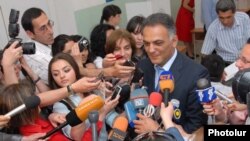 Yerevan Mayor Gagik Beglarian speaks to reporters after casting his ballot.