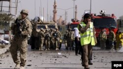 Afghanistan -- NATO soldiers inspect the scene of a suicide bomb attack in Kabul, Afghanistan, 11 October 2015. 