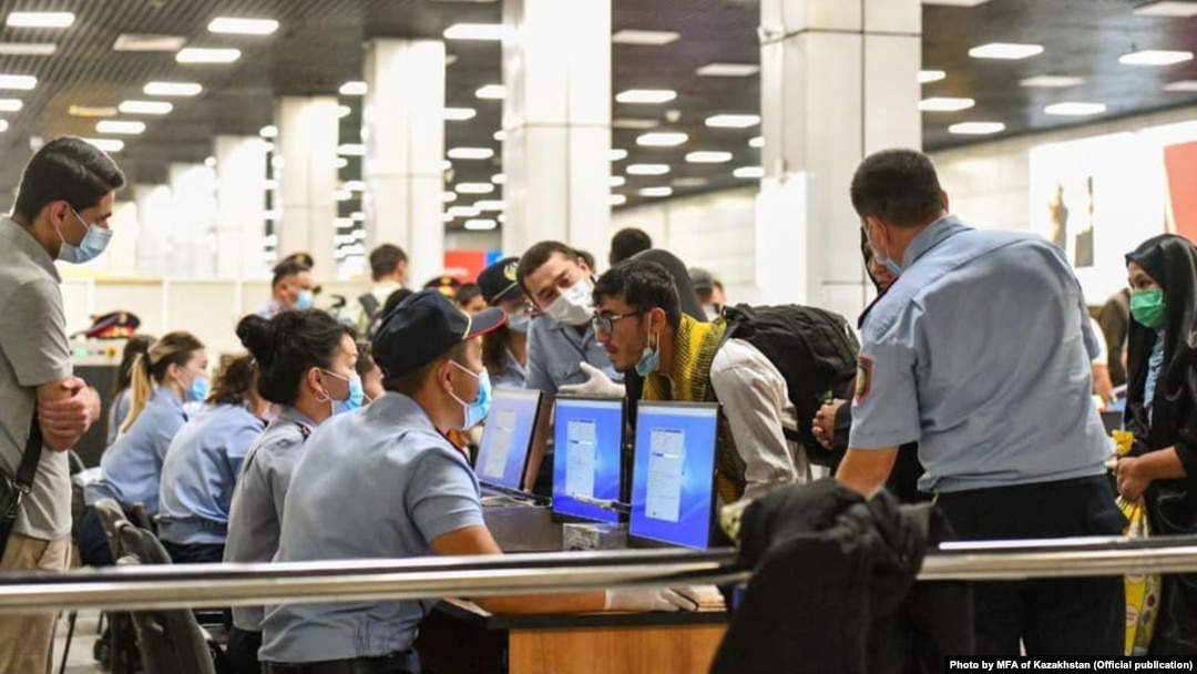Ethnic Kazakhs arrive at Almaty airport from Kabul in September. 