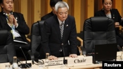 Japan's Environment Minister Ryu Matsumoto stands up after delivering a speech at the talks in Nagoya today.