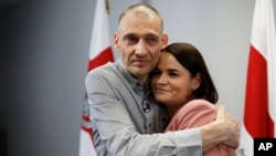 Belarusian opposition activist Syarhey Tsikhanouski embraces his wife, opposition leader Svyatlana Tsikhanouskaya, after his release from prison in June.