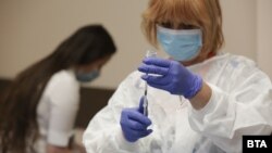 A health worker in Bulgaria prepares an inoculation using the AstraZeneca vaccine in February. (file photo)