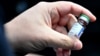 SERBIA -- Serbian President Aleksandar Vucic holds a vial containing the Sputnik V coronavirus vaccine during his visit to Belgrade's Torlak Institute, where the vaccine has been manufactured, in Belgrade, April 15, 2021