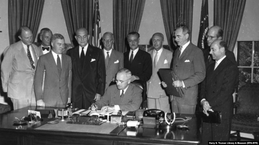 U.S. President Harry S. Truman signs a proclamation declaring into effect the 12-nation North Atlantic Treaty in the Oval Office of the White House on August 24, 1949.