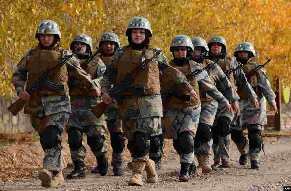 Female Afghan border police personnel take part in a ceremony at a police training center on the outskirts of Herat. (AFP/Aref Karimi)