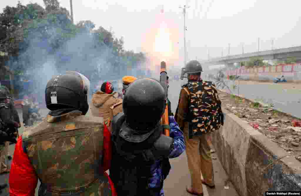 Riot police fires tear gas towards demonstrators during a protest in Seelampur on December 17.