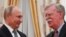 Russian President Vladimir Putin (left) shakes hands with U.S. national-security adviser John Bolton in Moscow.