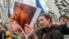 Moldovan protesters set posters depicting Russian President Vladimir Putin on fire during a rally against Russia's annexation of Ukraine's Crimea, near the Russian Embassy in Chisinau, on April 6.