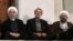 Iranian President Hassan Rohani (left) and judiciary chief Sadegh Larijani (right, with parliament speaker Ali Larijani in between) have traded barbs over the arrest of a billionaire.