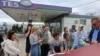 Ukraine -- People put their names on a list to join the queue for fuel at a gas station