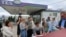 Ukraine -- People put their names on a list to join the queue for fuel at a gas station