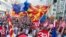 People wave Macedonian and European flags as they attend a campaign rally in Skopje on September 16 for a "yes" vote ahead of a referendum scheduled for later this month.