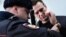 A Russian policeman removes handcuffs from Kremlin critic Aleksei Navalny after he was arrested during a March 2017 anti-corruption rally in Moscow.