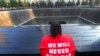 U.S. -- A woman reflects at the 9/11 Memorial during ceremonies marking the 12th anniversary of the 9/11 attacks on the World Trade Center in New York. September 11, 2013. 