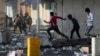 Iraqi security forces try to disperse anti-government protesters in downtown, Baghdad, Iraq, Tuesday, Nov. 12, 2019. (AP Photo/Hadi Mizban)