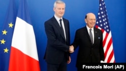 French Economy Minister Bruno Le Maire (left) welcomes U.S. Commerce Secretary Wilbur Ross prior to their meeting in Paris on May 31.