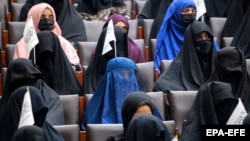 Female Afghan students listen to women speakers prior to a pro-Taliban rally outside the Shaheed Rabbani Education University in Kabul on September 11, 2021.