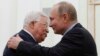 Russian President Vladimir Putin (right) embraces Palestinian Authority President Mahmud Abbas during a meeting at the Kremlin in Moscow on February 12.