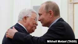 Russian President Vladimir Putin (right) embraces Palestinian Authority President Mahmud Abbas during a meeting at the Kremlin in Moscow on February 12.