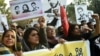 Pakistani rights activists hold images of bloggers who have disappeared, during a protest in the eastern city of Lahore on January 12.