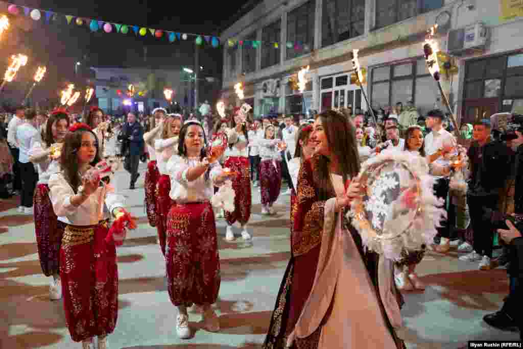 Women in Ribnovo, southwestern Bulgaria, on March 17 during a wedding ceremony of the village's Muslim Pomak community. The mountain village is famous for its days-long weddings in which brides are covered in white paste and sequins.Photo by Ilian Ruzhin/RFE/RL's Bulgarian Service.