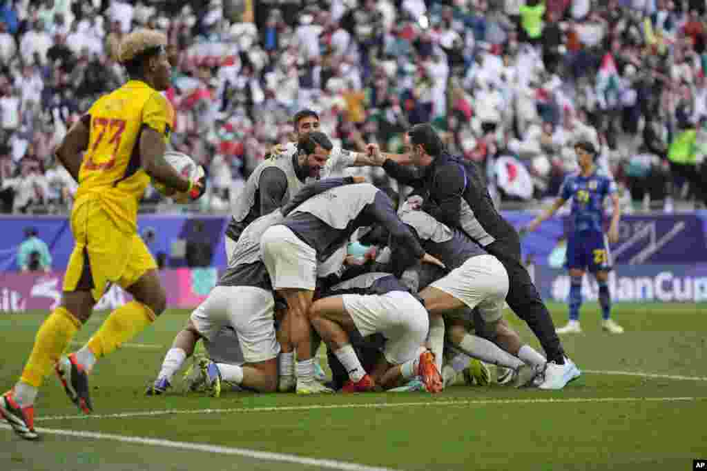 Iranian soccer players celebrate after they scored a late winner in their Asian Cup quarterfinal against Japan.&nbsp;