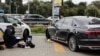 A police officer examines Serhiy Shefir's car after the shooting on September 22. 