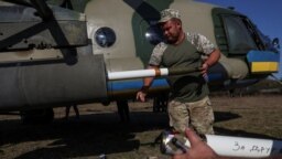 A Ukrainian serviceman loads unguided missiles into a launcher on a military Mi-8 helicopter in eastern Ukraine on September 29. 