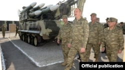 Azerbaijan - President Ilham Aliyev inspects weapons put on display at the site of exercises held by the Azerbaijani army, 26Jun2014.