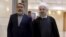 IRAN -- Iranian President Hassan Rohani (R) walks with Interior Minister Abdolreza Rahmani Fazli at the Interior Ministry in Tehran, December 21, 2015