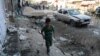 A boy walks at the site of a suicide bomb attack near a Shi'ite mosque in Kabul on September 29.