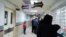 People standing in front of a cashier's window at a hospital in Iran, undated. FILE PHOTO