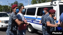 Police detain protesters in Yerevan on June 14.